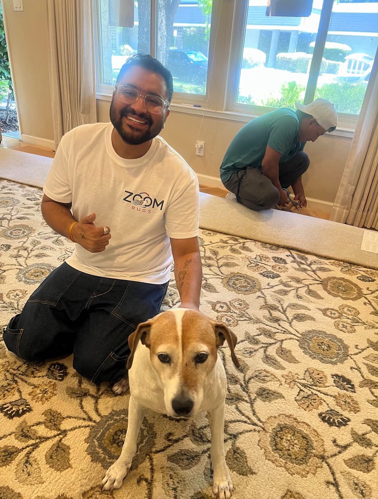 Gaurav Sharma, owner of Zoom Rugs, with a client’s rug and pet